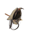 The inside of this shoulder bag has a hanging zippered pocket  and a large main compartment.