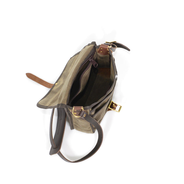 The inside of this shoulder bag has a hanging zippered pocket  and a large main compartment.