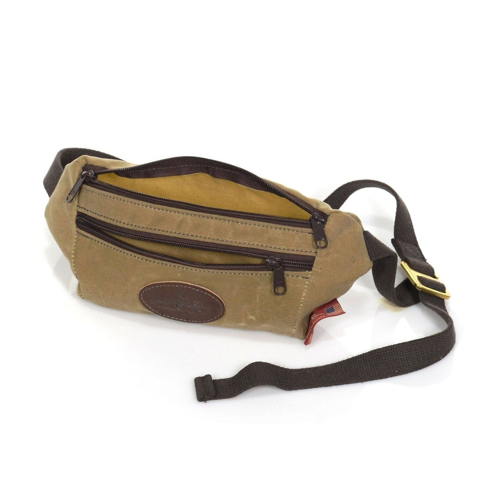 Crafted out our lighter 10.10 oz waxed canvas, strong webbed cotton, premium leather, and durable solid brass. Features a small front zipper pocket and a larger zippered main compartment. 