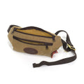 Crafted out our lighter 10.10 oz waxed canvas, strong webbed cotton, premium leather, and durable solid brass. Features a small front zipper pocket and a larger zippered main compartment. 
