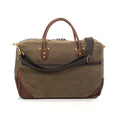 Rear view of the brief bag to show back outside slip pocket and webbed cotton shoulder strap.