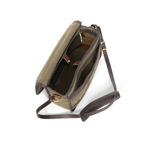 The interior has a small slip sleeve and a larger main compartment. A solid brass snap is on top of the interior to secure your load.